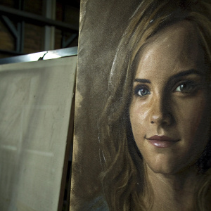 Realistic charcoal portrait of Emma Watson. Focus on facial contours and subtle expression. Varied shading to create depth and texture.