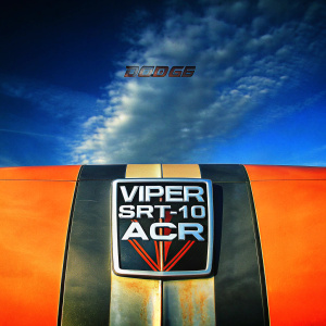 Digital artwork showcasing the logo for Dodge Viper SRT-10 ACR. The emblem features a fierce snake, set against a black and white backdrop. The Dodge brand name and 'Viper SRT-10 ACR' text are prominently displayed in bold, aggressive font.