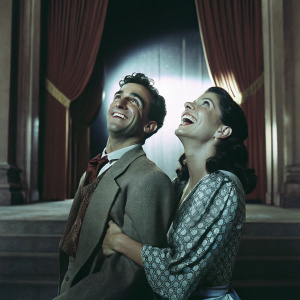Brandon Uranowitz and Stephanie J Block laughing and posing together. Miss Saigon themed red carpet event backdrop