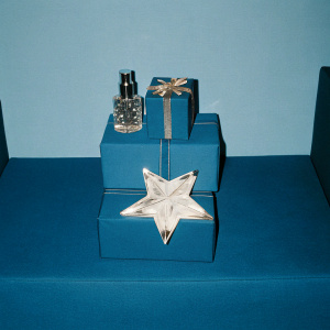 Star-shaped perfume display for Thierry Mugler's Angel Eau de Parfum. Luxurious packaging and gift box arrangement. High-end cosmetic boutique