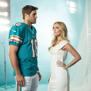 Jay Cutler in Miami Dolphins jersey, Kristin Cavallari in elegant dress. Both looking serious. Studio backdrop, soft focus