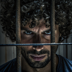 Close-up of Cristiano Ronaldo. Intense gaze, curly hair, stubble.