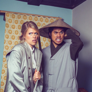 Cassie Cage, blonde hair, worried expression, and Raiden, fierce face, traditional hat, posing for a promotional poster of Mortal Kombat X, set against a vibrant, patterned backdrop.