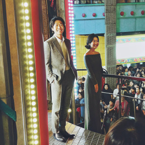 Gong Yoo and Kim Su-an attending a promotional event for their new film. Crowded venue, colorful stage setup