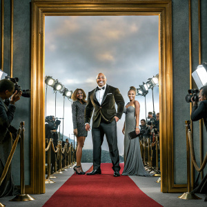 Dwayne Johnson, Lauren Hashian, and Jasmine Johnson at a glitzy awards show. Lavish red carpet scene.
