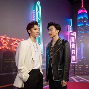 Lay Zhang Yixing with his wax figure at Madame Tussauds. The duo stands in front of a neon-lit cityscape backdrop.