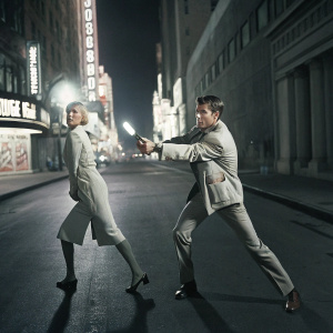Judy Hopps and Nick Wilde in an action-packed scene from Zootopia. Bright city lights