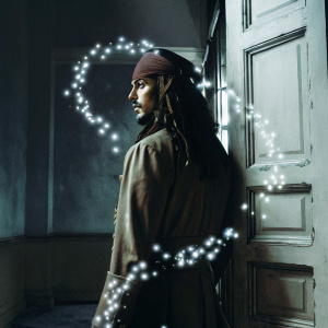 Digital art featuring a silhouette of Jack Sparrow from Pirates of the Caribbean series. Set against a sepia-toned, grayscale backdrop. Surrounding particles resemble smoke, giving an ethereal effect.