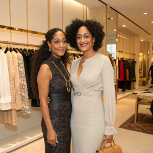 Tracee Ellis Ross and Chudney Ross in a chic boutique. Both stylishly dressed. Background features clothing racks and luxury apparel.