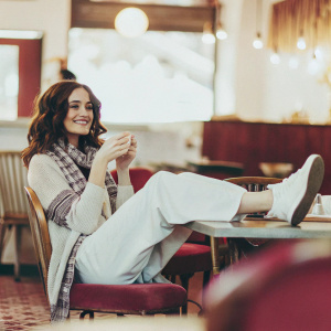 Emmy Rossum in a casual outfit, hanging out in a cozy cafe. Black and white photo