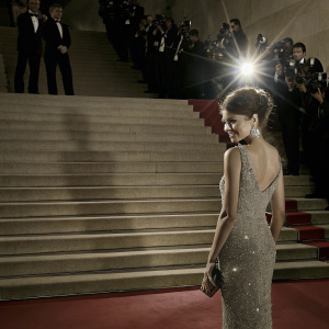 Zendaya, in a silver sequined dress, poses elegantly at the Cannes Film Festival. Red carpet with flashing cameras