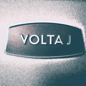 The Volta J logo features bold, sleek design. White text on vibrant blue background.