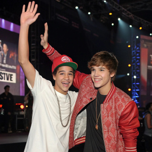 Austin Mahone and Justin Bieber at the Live Nation concert promotion event. Posing for a photo, giving a high-five.