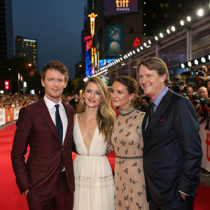 Eddie Redmayne, Amber Heard, Alicia Vikander, and Tom Hooper on the vibrant and crowded film festival red carpet.