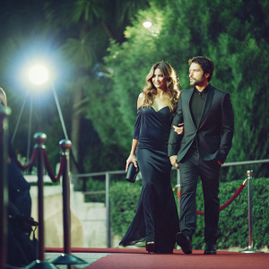 Freddy Rodriguez and Elsie Rodriguez walking the carpet. TIFF Film Festival. Dark attire, Hollywood spotlight.