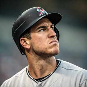 Close-up shot of J.T. Realmuto. Baseball player frowning intently. Grey stadium background