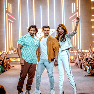 Salman Khan, Sooraj Pancholi, and Athiya Shetty attending a glitzy Bollywood awards show. Neon lights and audience in the background.