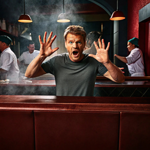 Chef Gordon Ramsay, looking shocked, waving his hands wildly. In casual t-shirt. Candid photo at a bustling kitchen.