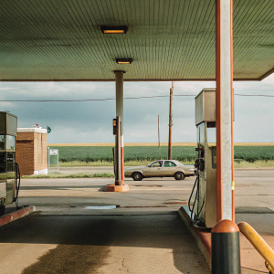 Generate a gas station scene in the photographic style of Stephen Shore.