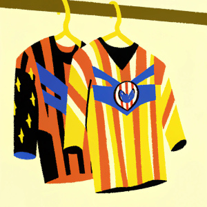 A Spider-Man themed Atletico de Madrid soccer jersey on a wooden hanger against a plain beige wall. The jersey features red and white stripes, blue accents, and the iconic Spider-Man emblem.