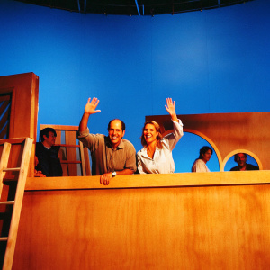 Jeffrey Tambor and Kasia Ostlun on the set of their new TV show, smiling and waving at the cameras.
