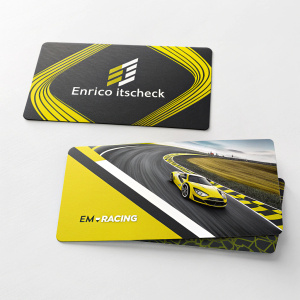 Enrico Itscheck's sleek business cards from Em-Racing showcased. Each card features a vibrant racing track design in bold yellow and black hues, laid out in a dynamic array.