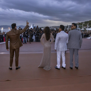 Celebrity gathering: Akshay Kumar, Katrina Kaif, Ajay Devgn, and Karan Johar at a bustling film festival. Crowds and flashing cameras in the background.