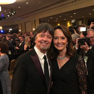 Ken Burns and Julie Deborah Brown at an awards ceremony. Crowded room with flashing cameras
