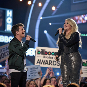 Charlie Puth and Meghan Trainor, on the Billboard Music Awards stage. Surrounded by cheering crowd.