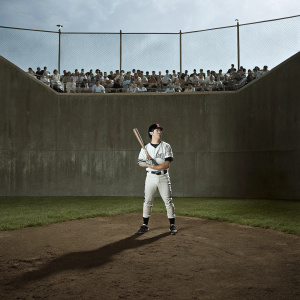 Nori Aoki, San Francisco Giants player, intense focus on the ball. Green outfield with spectators in the background.