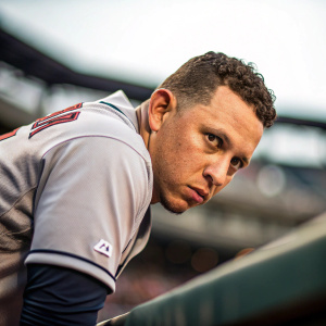 Asdrubal Cabrera, baseball player, posing for an intense close-up shot. Lean forward, direct gaze, blurred stadium background
