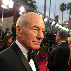 Close-up of Sir Patrick Stewart. Grey-haired, stern face. Hollywood award show, red carpet event.