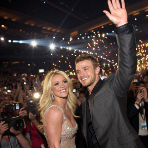 Britney Spears and Justin Timberlake at a Grammy Awards after-party. Large crowd of fans and paparazzi