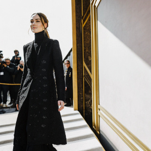 Keira Knightley, elegant in a black, high-collared jacket with intricate details, stands confidently on the red carpet at the Elle Style Awards.