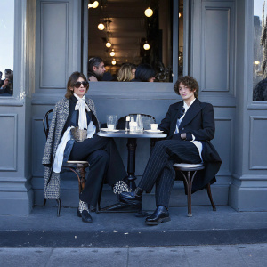 Alexa Chung and Orson Fry, stylishly dressed, at a chic cafe in Soho. Fashion week event ambiance
