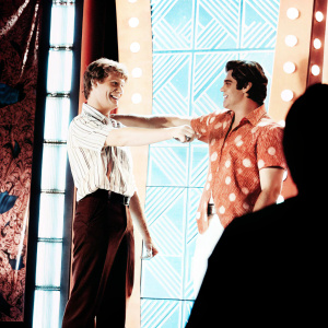 Jace Norman and John Stamos at the Nickelodeon Kids' Choice Awards. Playful interaction. Colorful stage backdrop.