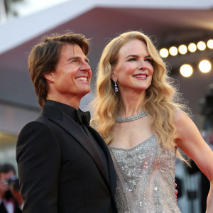 Tom Cruise and Nicole Kidman at the Venice Film Festival. Tom in a black blazer, Nicole in a silver sequined gown.