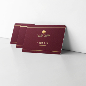 A sleek, polished display of business cards for Marco Valetti, Marketing Manager. The cards are lined up neatly in a row. Each card features 'Predaja' in gold text on a deep maroon background.