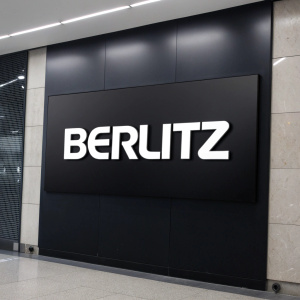 Modern graphic design of Berlitz logo. Bold, sans-serif font on sleek, black backdrop.