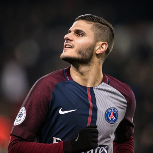 Close-up shot of Mauro Icardi. Dressed in PSG soccer jersey, posing confidently. Maroon and white colors. Team's logo prominently displayed.