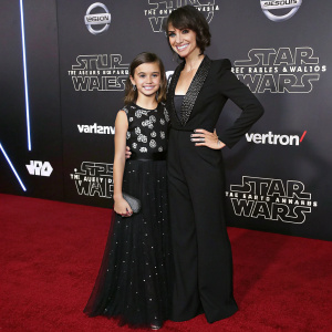 Constance Zimmer and her daughter Colette Zoe Lamoureux attending the Star Wars convention. Wearing formal attire. Backdrop features the Star Wars logo and sponsors.