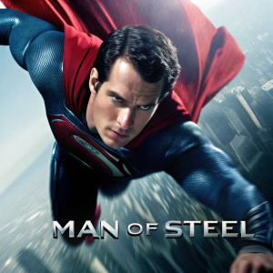 Promotional poster for 'Man of Steel'. Henry Cavill as Superman in mid-air. Dynamic pose with a determined expression. Cityscape blurred in background. Release date and viewing information in text.