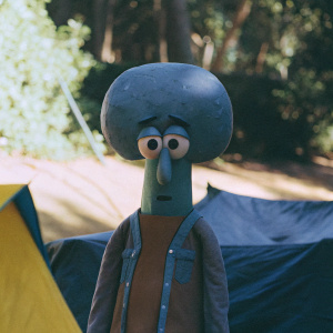 Digital art rendering of Squidward from SpongeBob SquarePants. Brightly colored, stylized illustration featuring Squidward with a large, circular blue head and brown body against a yellow backdrop.