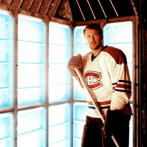 Tomas Tatar, hockey star, Montreal Canadiens jersey. Blue and white ice rink backdrop. Posing for official team portrait.