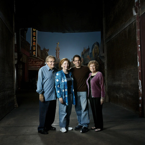 Family portrait: Jerry Stiller, Amy Stiller, Ben Stiller, Anne Meara. Set against vibrant Hollywood backdrop.