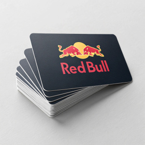A stack of sleek, modern business cards for Red Bull. Gray backdrop with bold, vibrant Red Bull logo. Stylized bull graphic in red and yellow colors. Cards are overlapping, creating a dynamic visual effect.