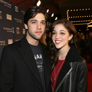 Josh Peck and Olivia Thirlby attending the Sundance Film Festival premiere. Josh in black suit and t-shirt, looking serious. Olivia smiling beside him.