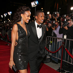 Selita Ebanks and Nick Cannon walking the carpet of a glitzy Hollywood premiere. Flashing cameras and enthusiastic fans surround them.