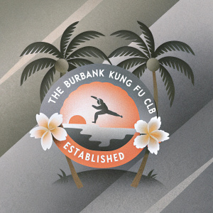 The official logo for The Burbank Kung Fu Club. Established in 1982. Vibrant colors, tropical theme, stylized martial arts scene.