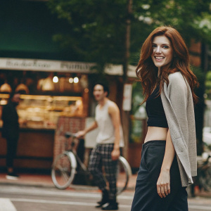 Anna Kendrick in casual attire, smiling for the camera. Street style shoot